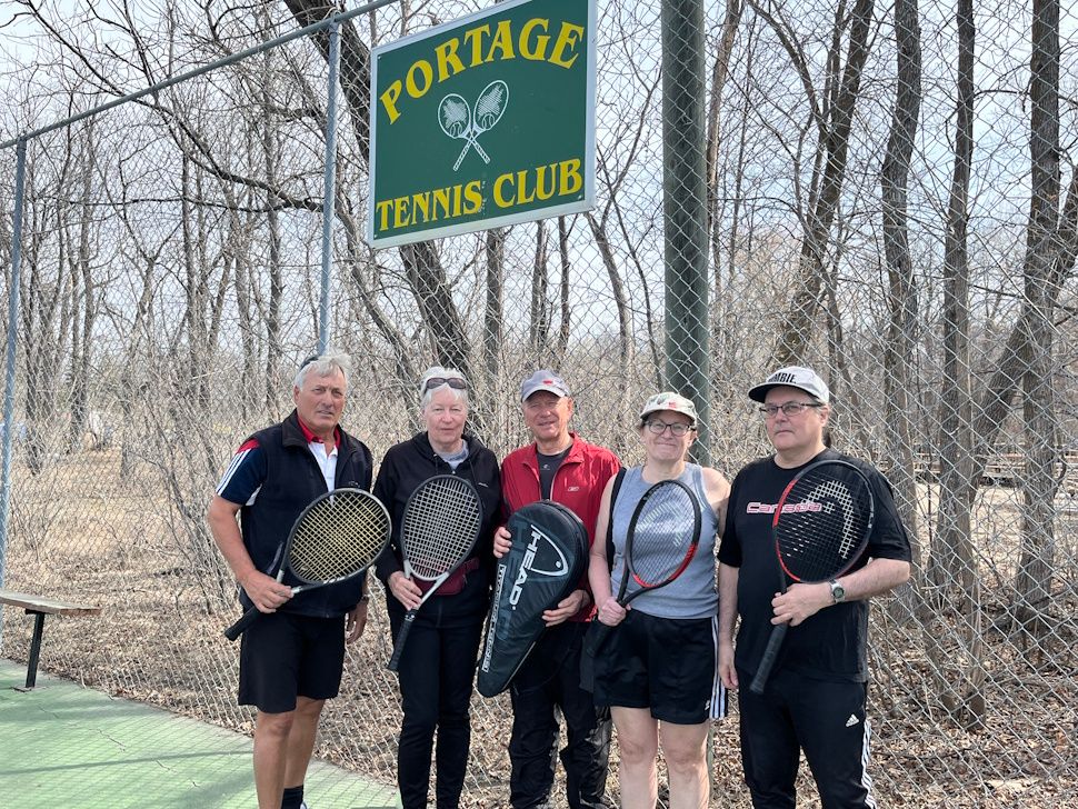 Members of the Portage Tennis Club standing together on outdoor tennis courts at Island Park in Portage la Prairie.